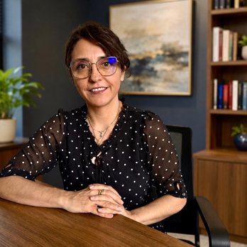 Marianela Uribe, owner and lead attorney of USG Law Group, at her desk